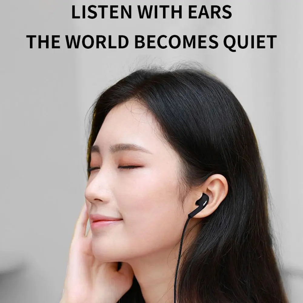A woman wearing a black wired earphone in her ear, showcasing comfort and design.