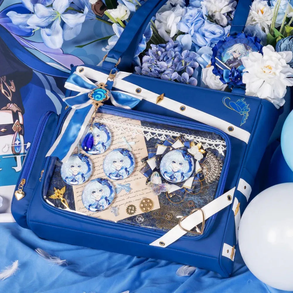 Close up of blue tote bag with clear display pocket showing decorative pins and lace