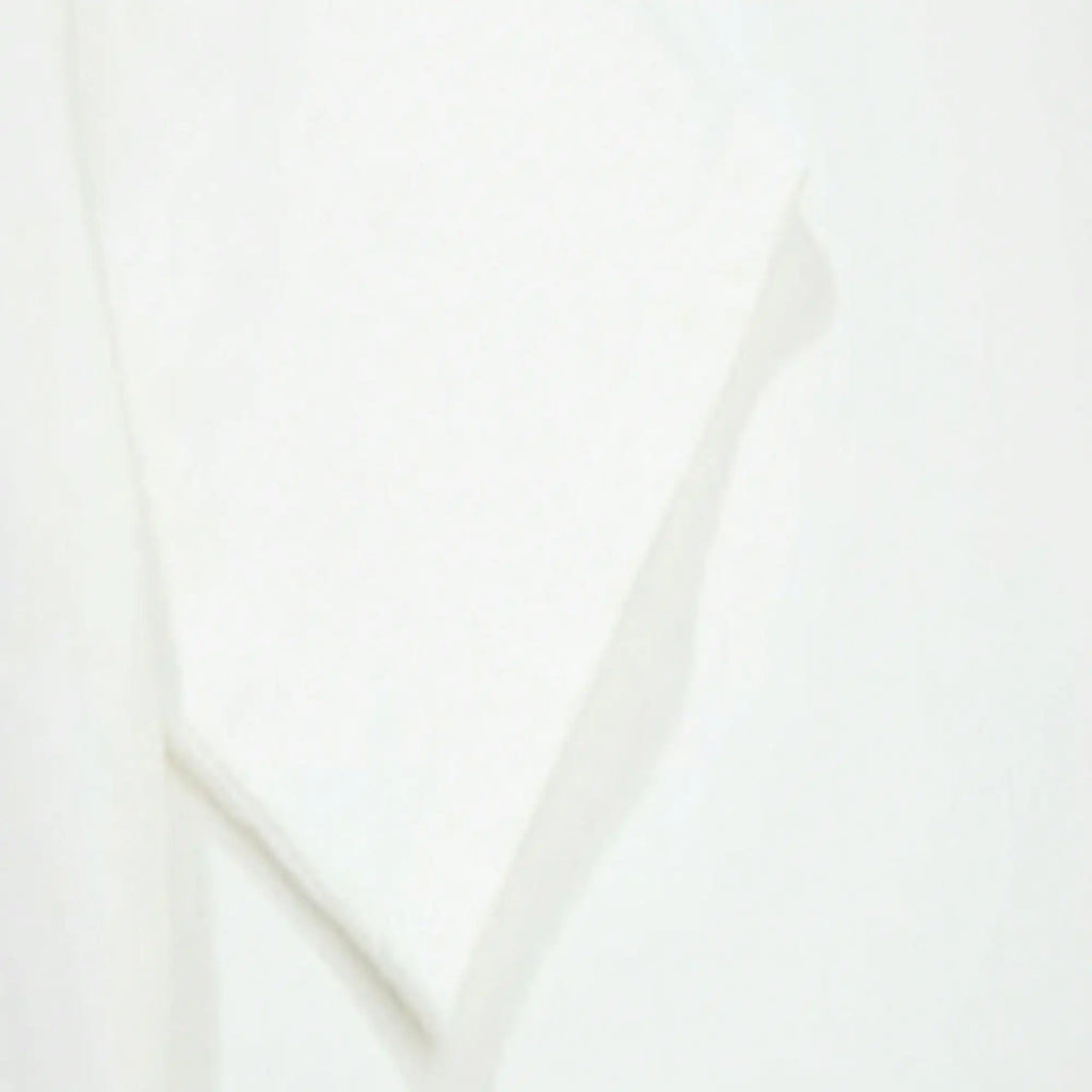 Close-up view of the white fabric texture of the t-shirt.