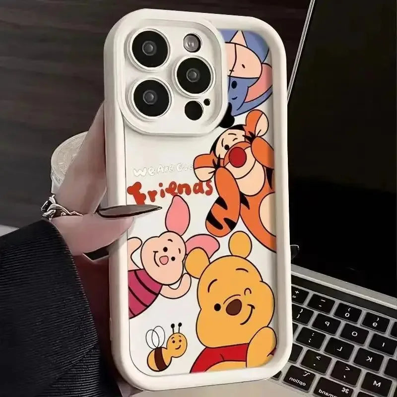 White phone case with colorful cartoon character illustrations held in a hand