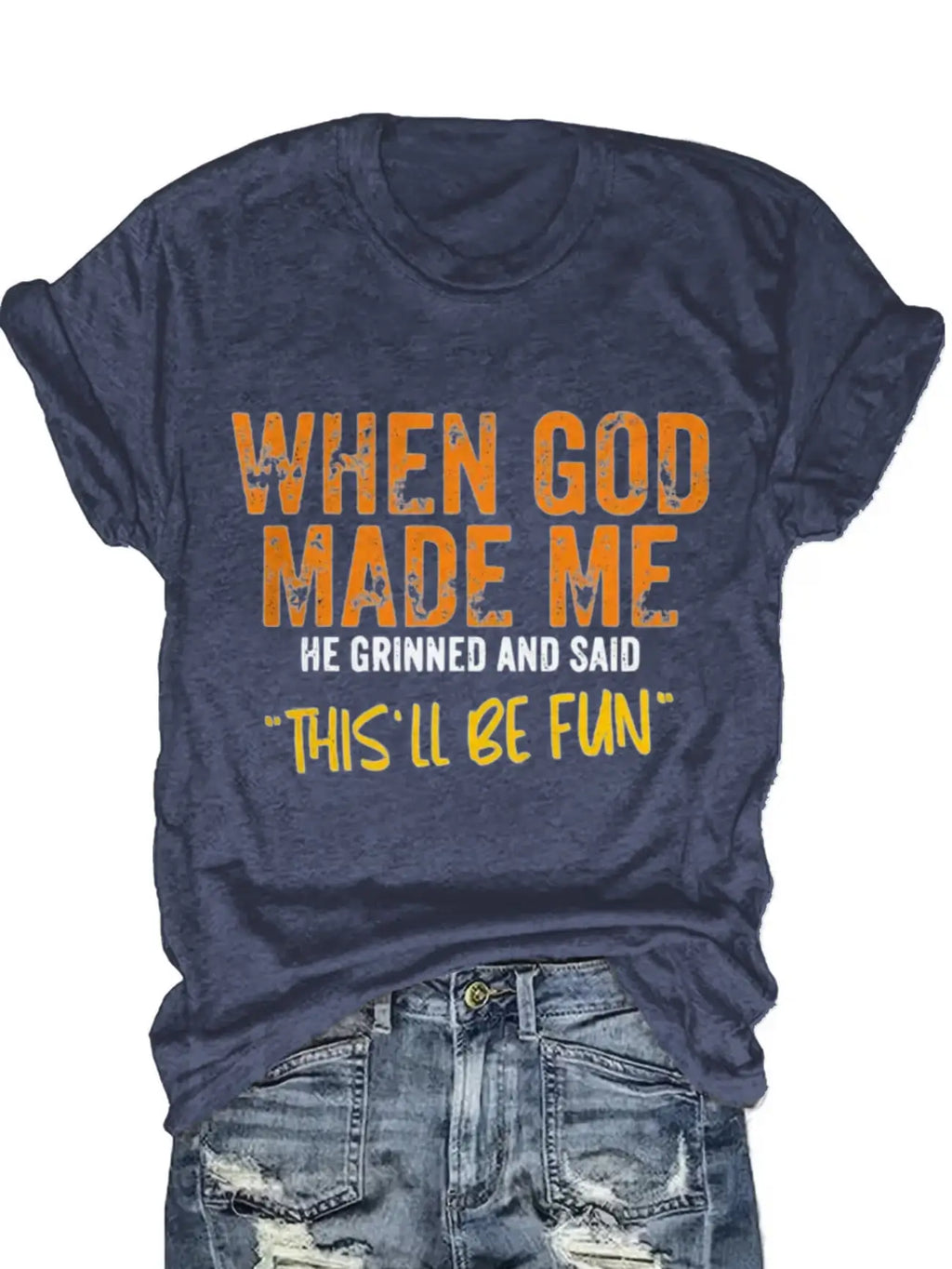 Blue short sleeve t-shirt with orange and white typography print worn tucked into denim jeans