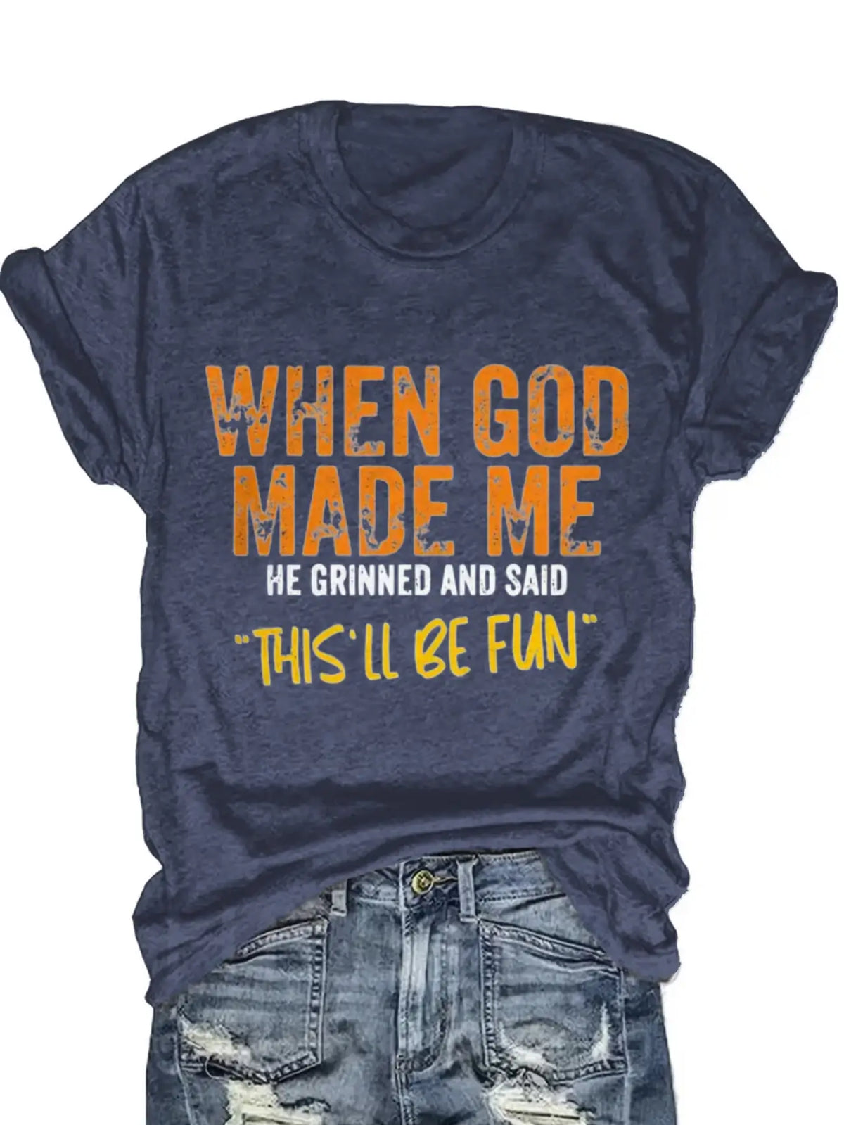 Blue short sleeve t-shirt with orange and white typography print worn tucked into denim jeans