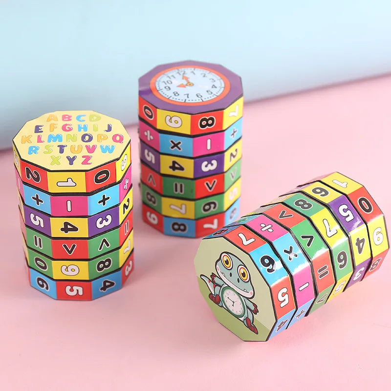 Three cylindrical math puzzle toys with numbers, symbols, a clock face, and cartoon characters