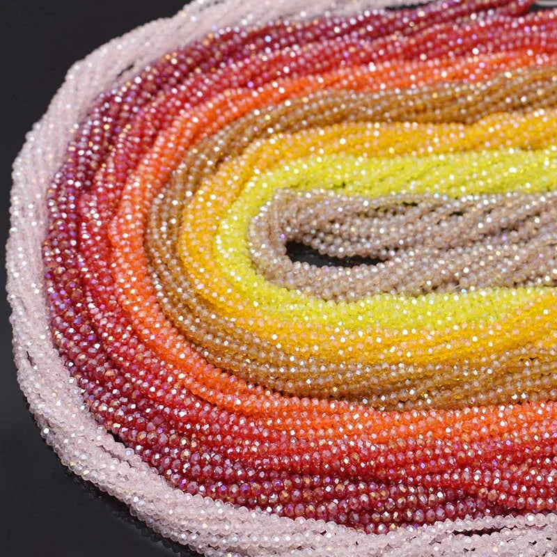 Curved strands of faceted rondelle crystal glass beads in warm tones