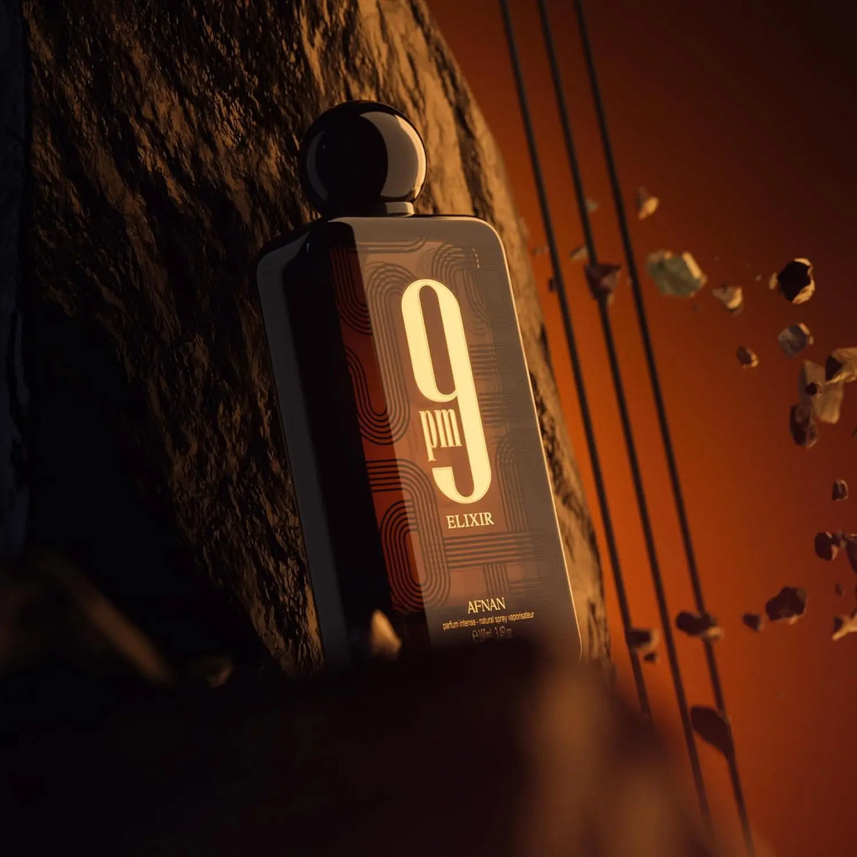 Fragrance bottle positioned on rocks in dramatic lighting