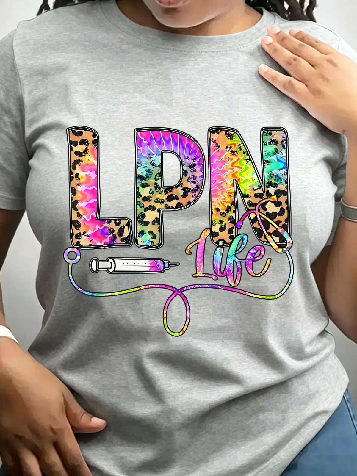 Grey crew neck t-shirt with leopard and tie-dye graphic text reading LPN Life featuring a syringe and stethoscope