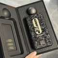 A black textured men's perfume bottle in an open presentation box showing fragrance notes.