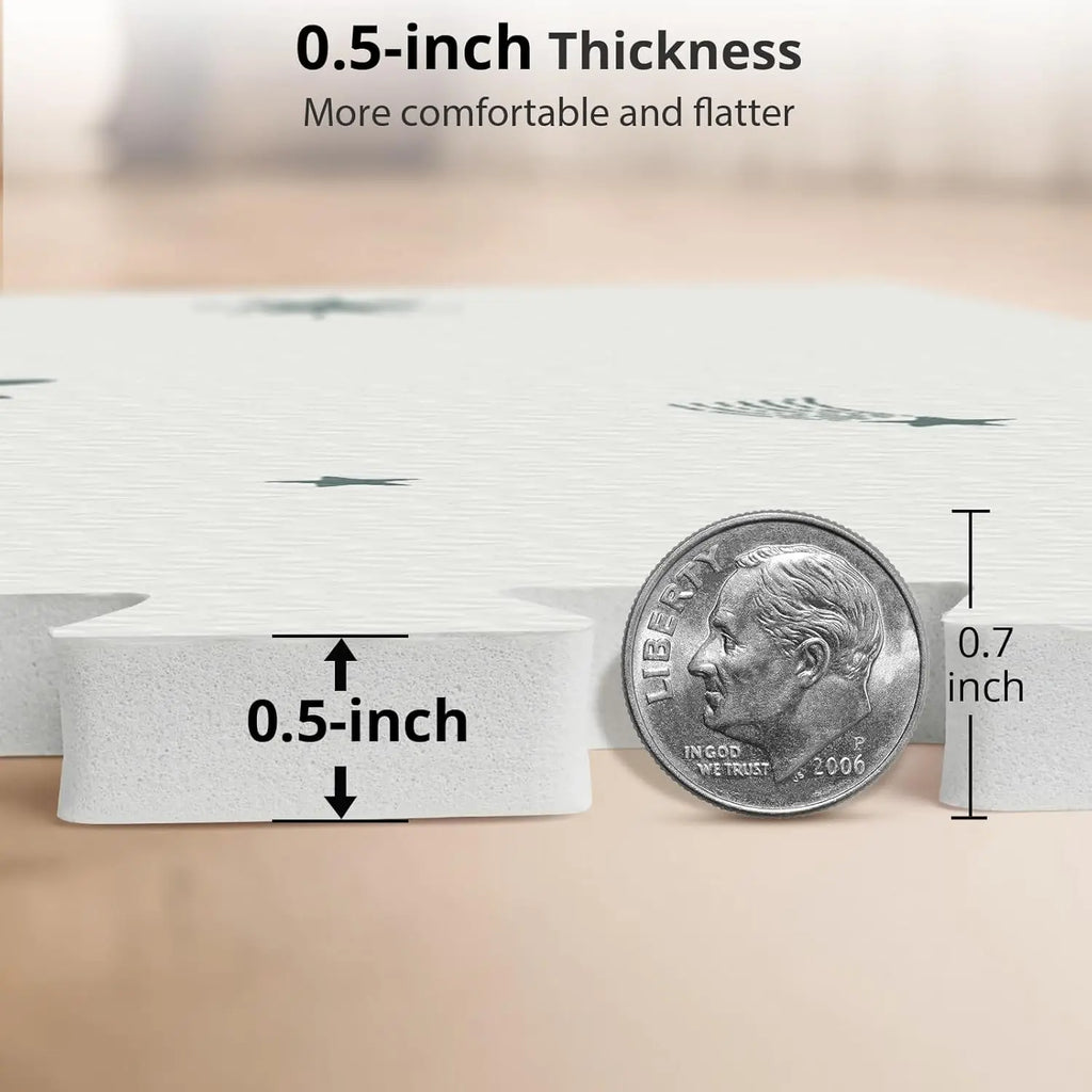 Close up of a foam play mat thickness showing a 0.5-inch measurement with a US dime coin for scale.