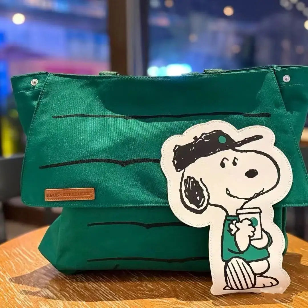 Green canvas tote bag with a cartoon dog patch featuring a coffee cup