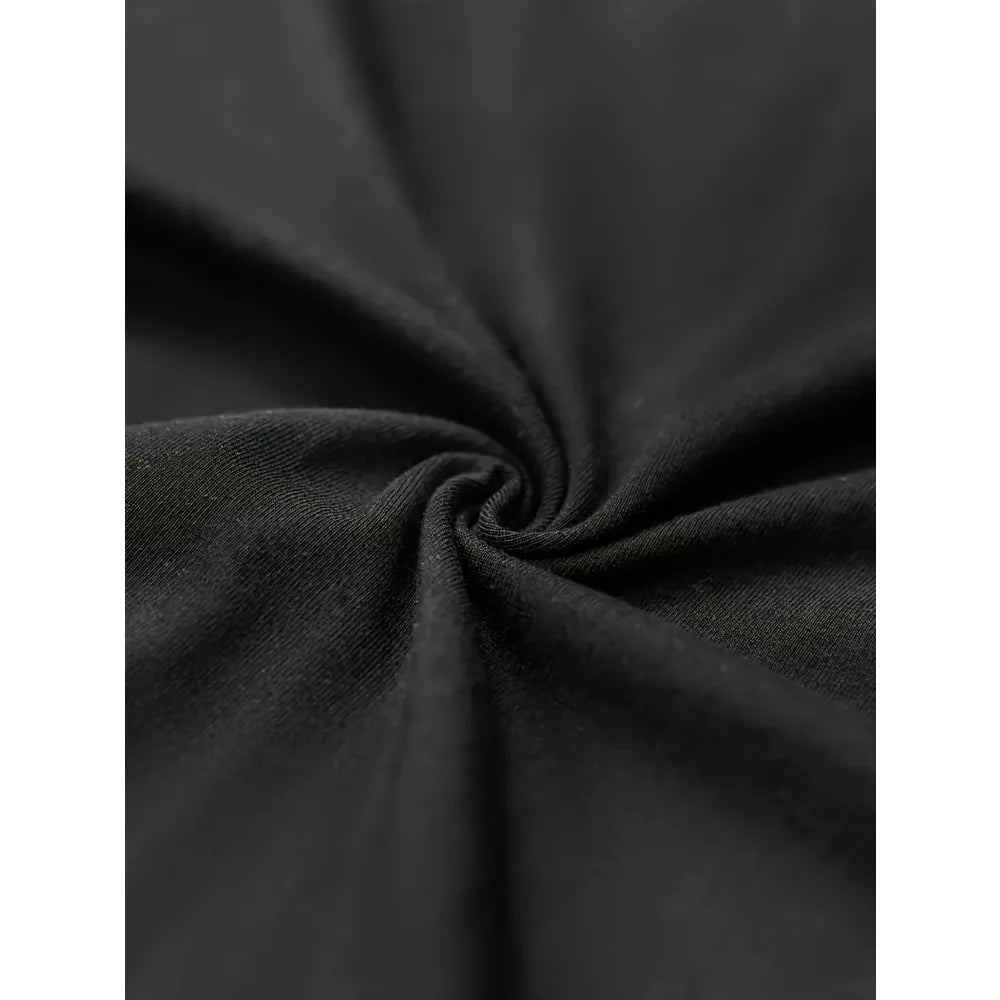 Close up detail shot of the texture of a black cotton t-shirt