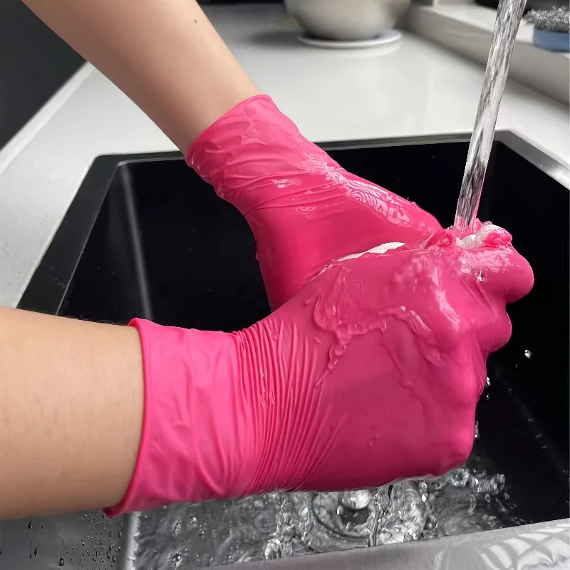 Person wearing rose red nitrile gloves while washing hands under running water