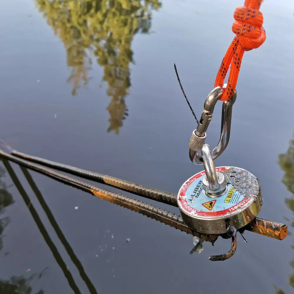 Fishing magnet pulling a metal rebar rod out of water.