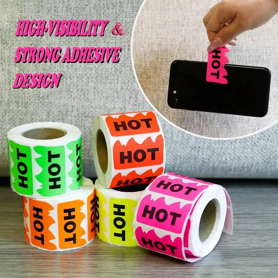 Several rolls of colorful flame-shaped stickers with a hand applying one to a black phone
