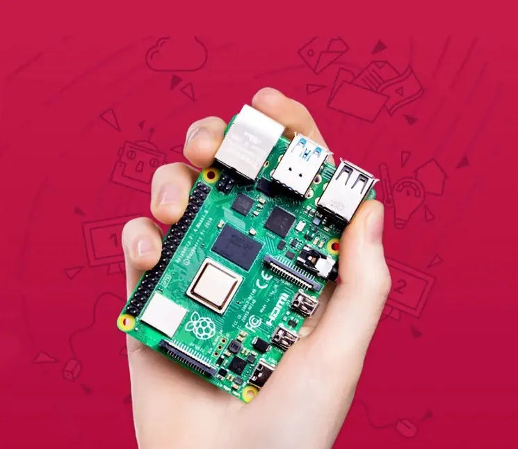 Hand holding a small green circuit board computer