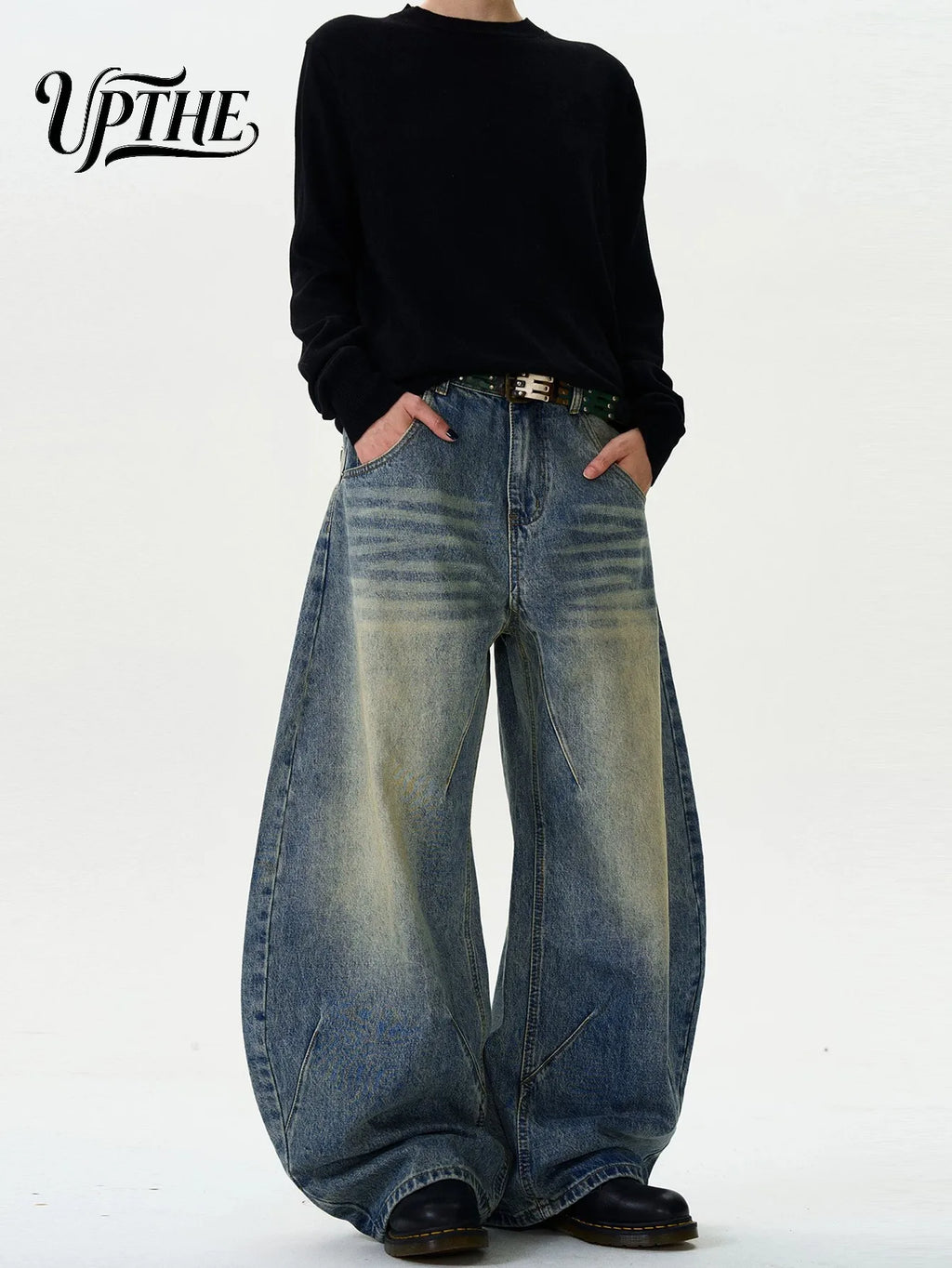 Model wearing vintage washed baggy wide leg denim jeans with black shirt