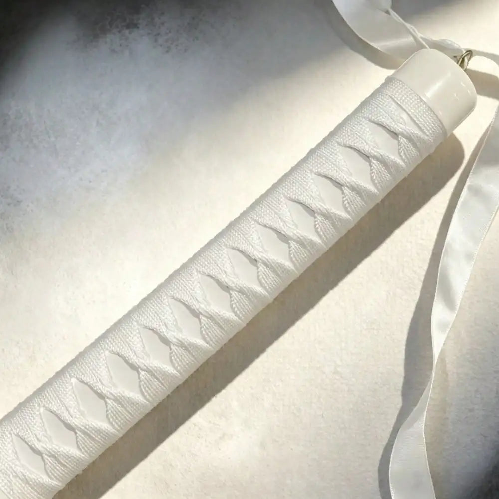 Close-up of white katana handle wrapping with ribbon