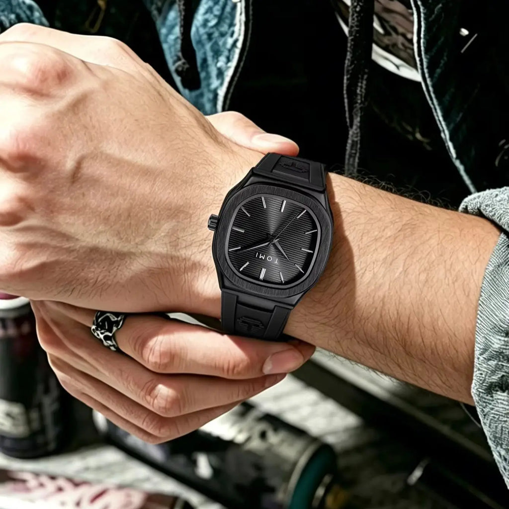 All-black square dial quartz watch worn on a man's wrist