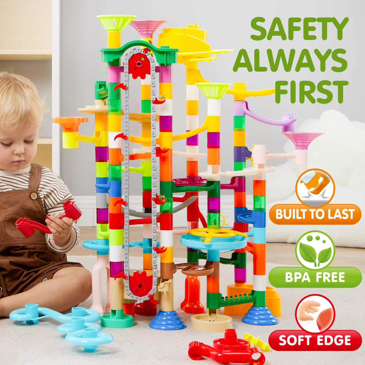 Toddler playing with a large colorful marble run toy set.