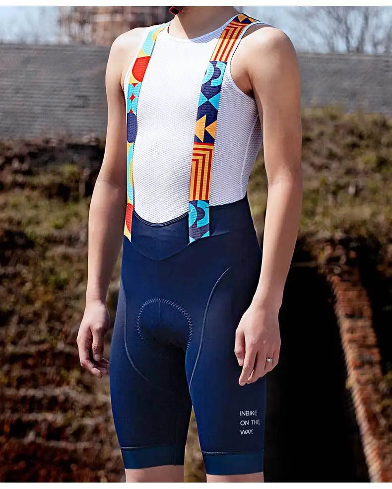 Man wearing navy cycling bib shorts with white mesh top and patterned shoulder straps