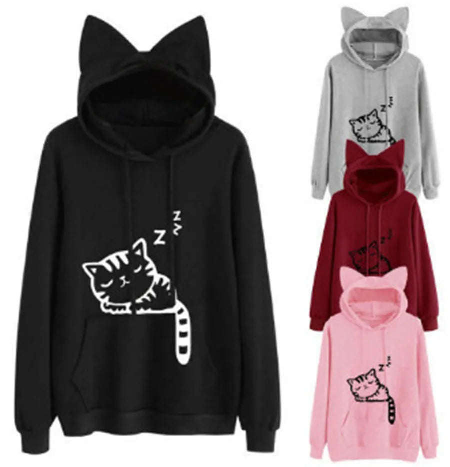 A group of cat-ear hoodies in black, grey, red, and pink, each with a sleeping cat print.