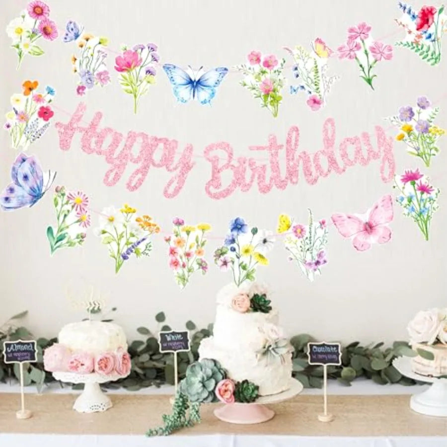 Birthday party table setting with a cake and a wildflower butterfly Happy Birthday banner hanging