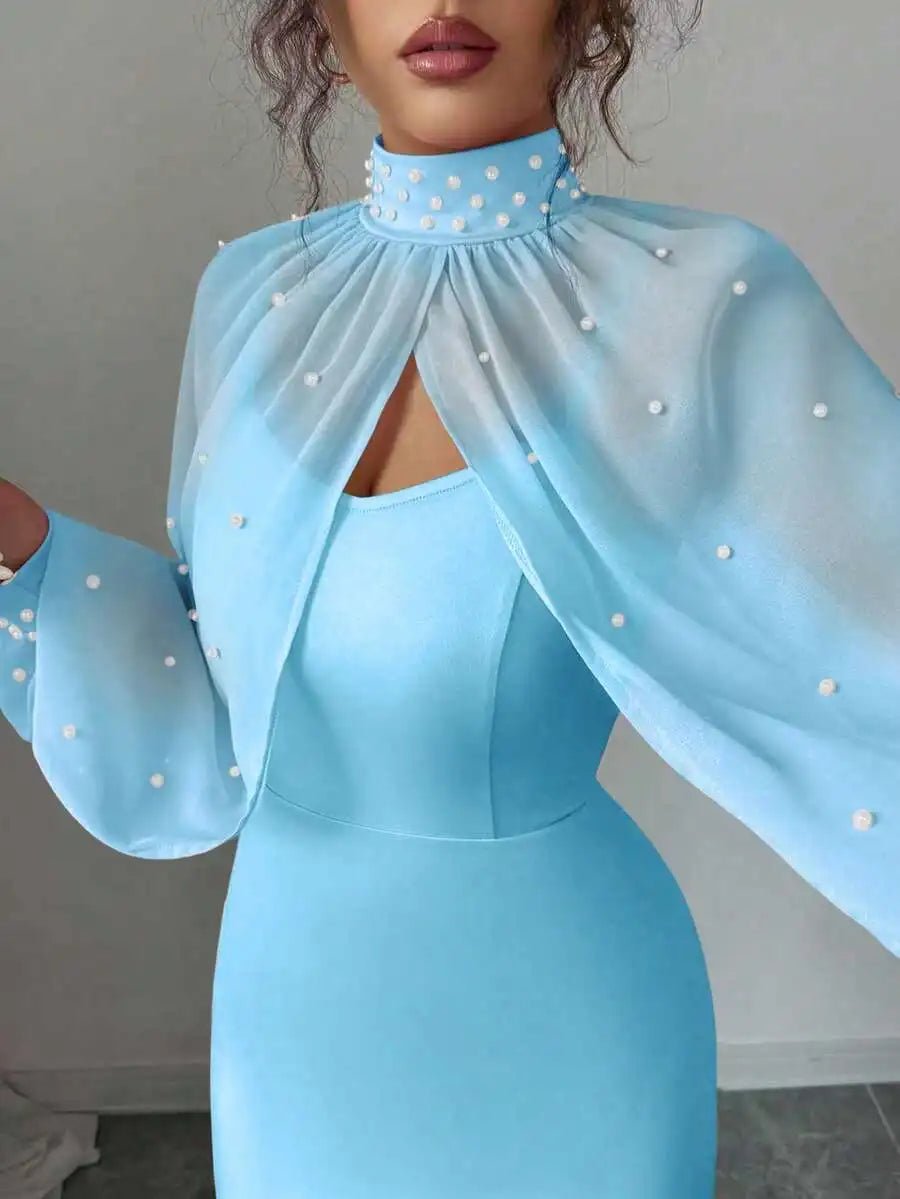 Close-up view of a light blue formal gown with pearl embellishments on the sheer cape.