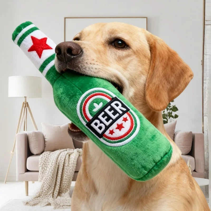 Green plush beer bottle shaped dog toy with a red star