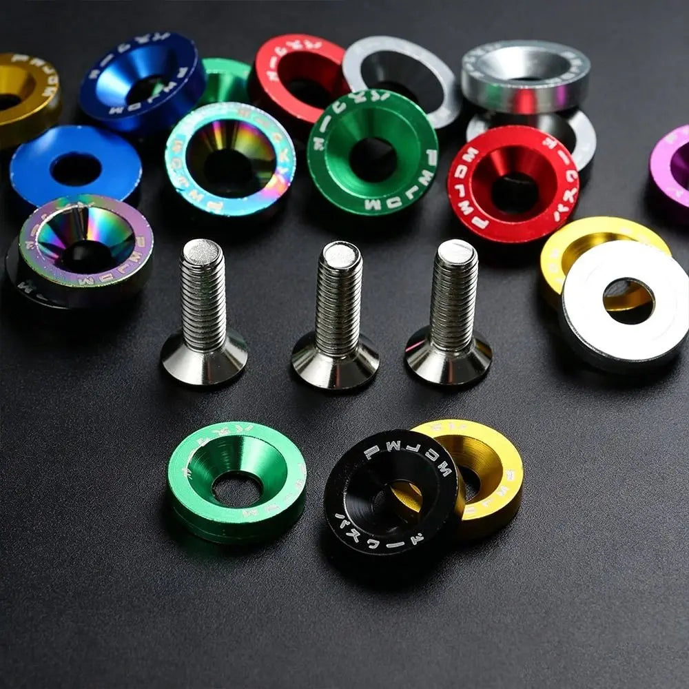 Several multicolored concave washers and steel screws laid out on a dark surface.