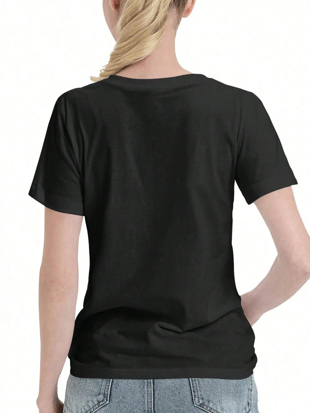 Back view of a woman wearing a plain black t-shirt with her hair tied up