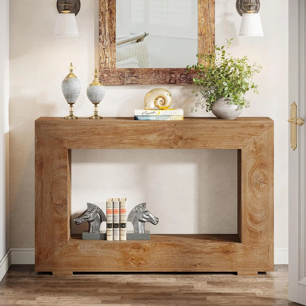 A rustic brown wooden console table in a living area featuring two horse head bookends and a seashell decor piece.