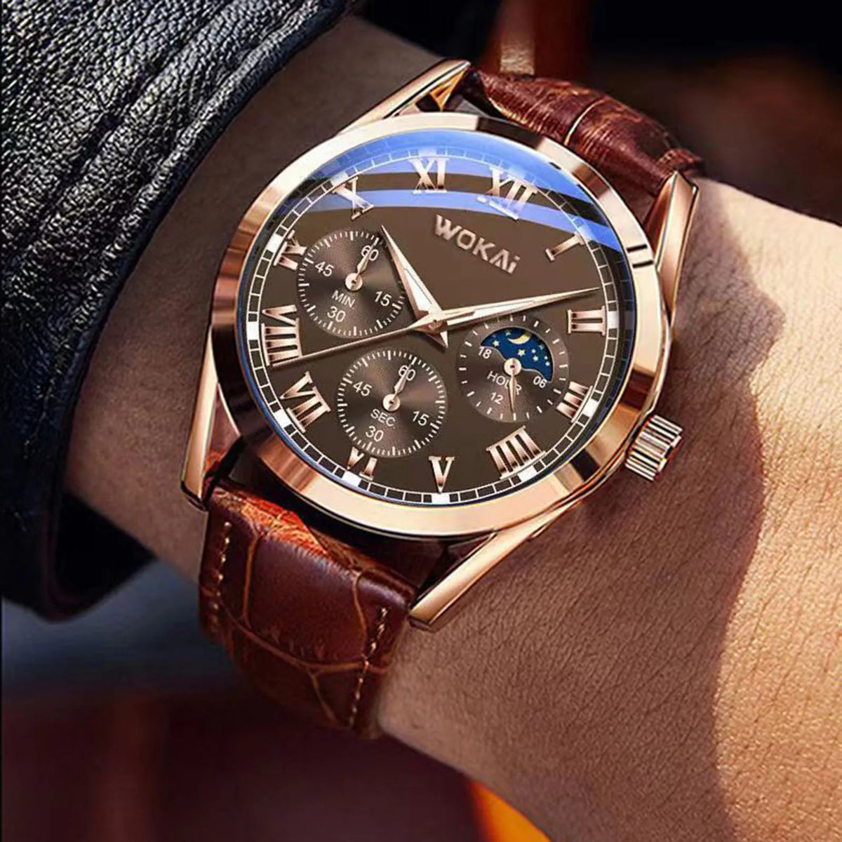 Rose gold tone quartz watch with brown leather strap worn on a wrist