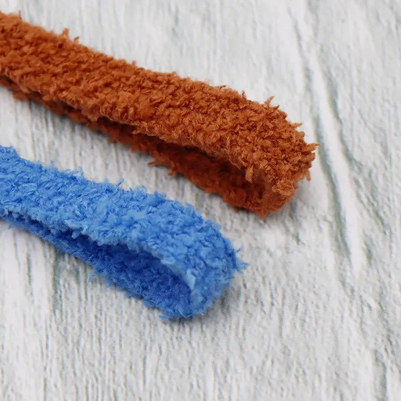 A macro shot of a brown and a blue fluffy plush shoelace texture.
