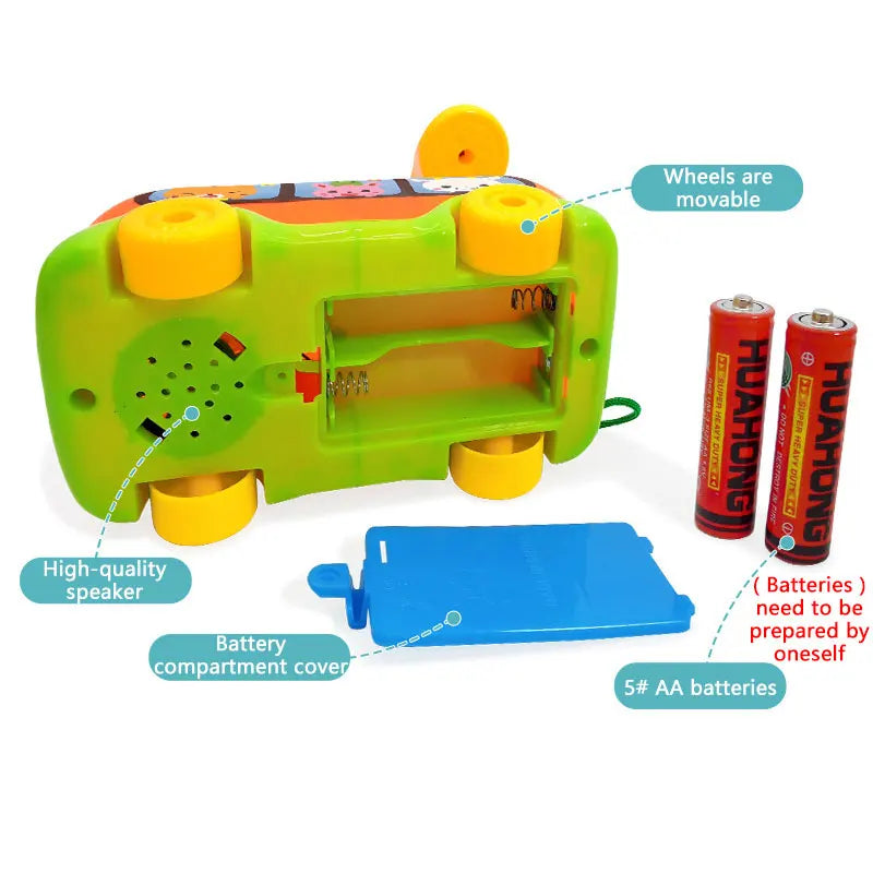 Bottom view of a toy bus showing the battery compartment and speaker with AA batteries