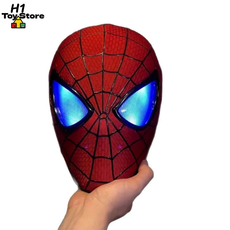 A person holding a red, light-up superhero mask with glowing blue eyes.