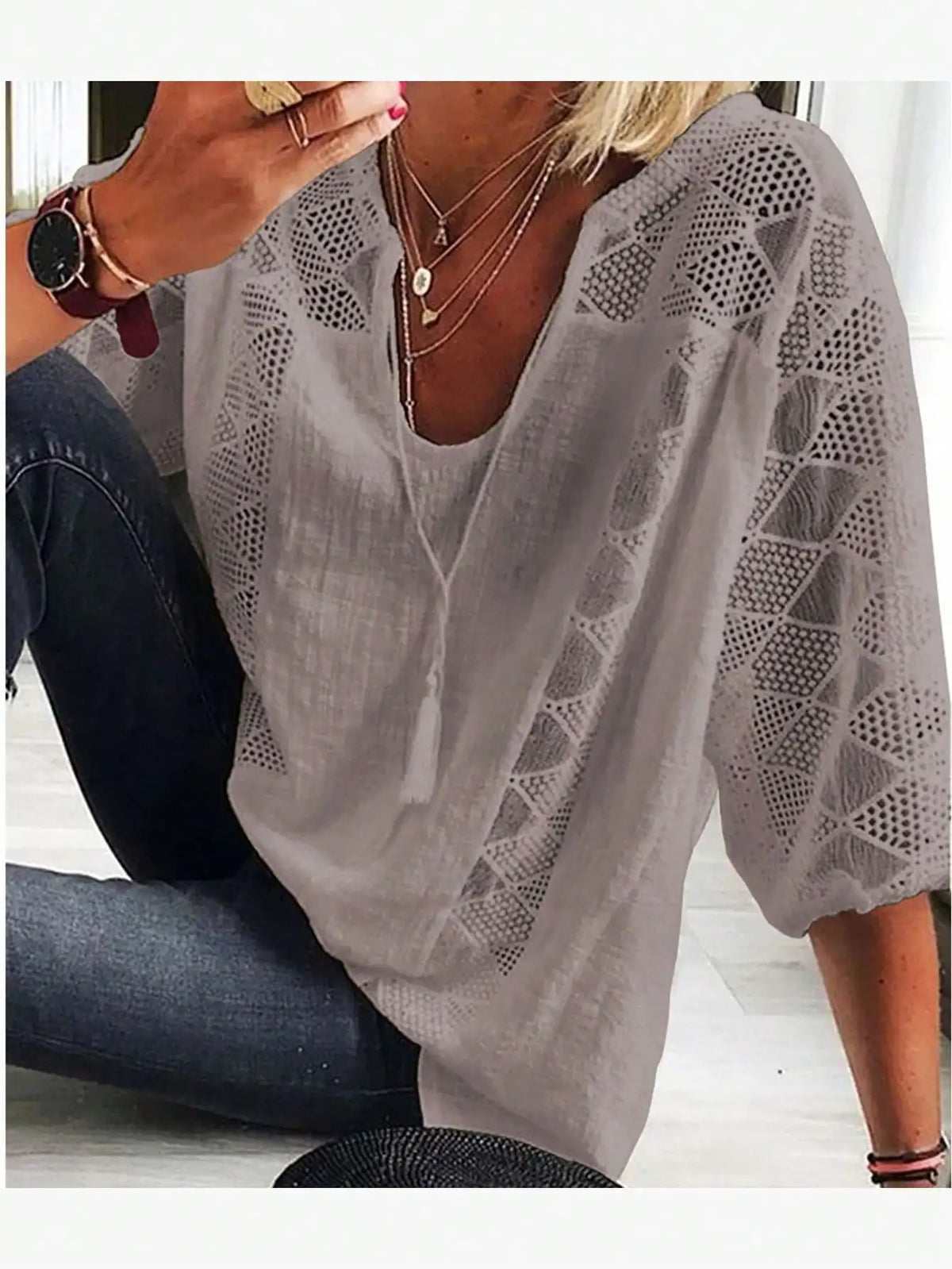 Women's light grey loose-fit blouse with lace inserts and tassel tie neck