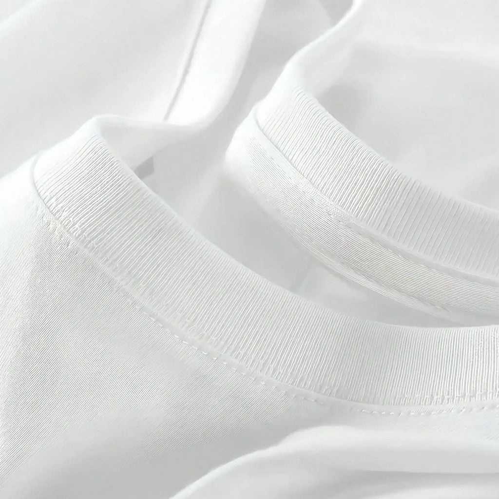 A close-up detail of the round neckline and stitching of the white t-shirt.