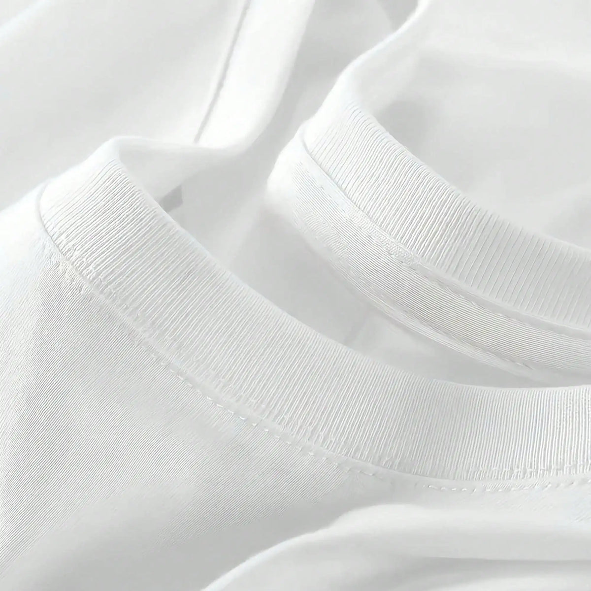 A close-up detail of the round neckline and stitching of the white t-shirt.