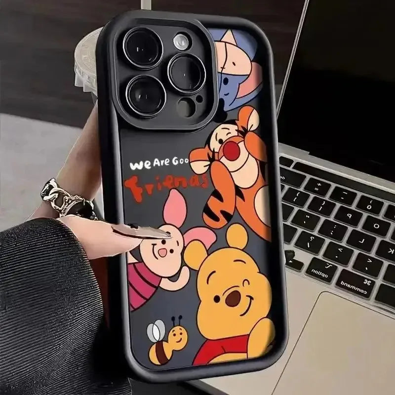 Black phone case with cartoon character illustrations held in a hand