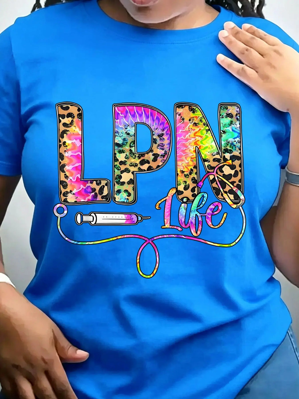 Bright blue crew neck t-shirt with leopard and tie-dye graphic text reading LPN Life featuring a syringe and stethoscope
