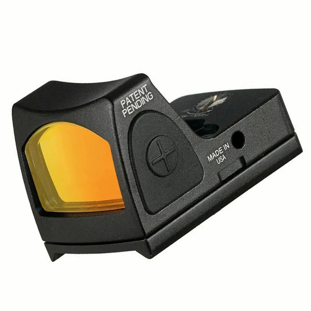 Black miniature red dot reflex sight with yellow lens