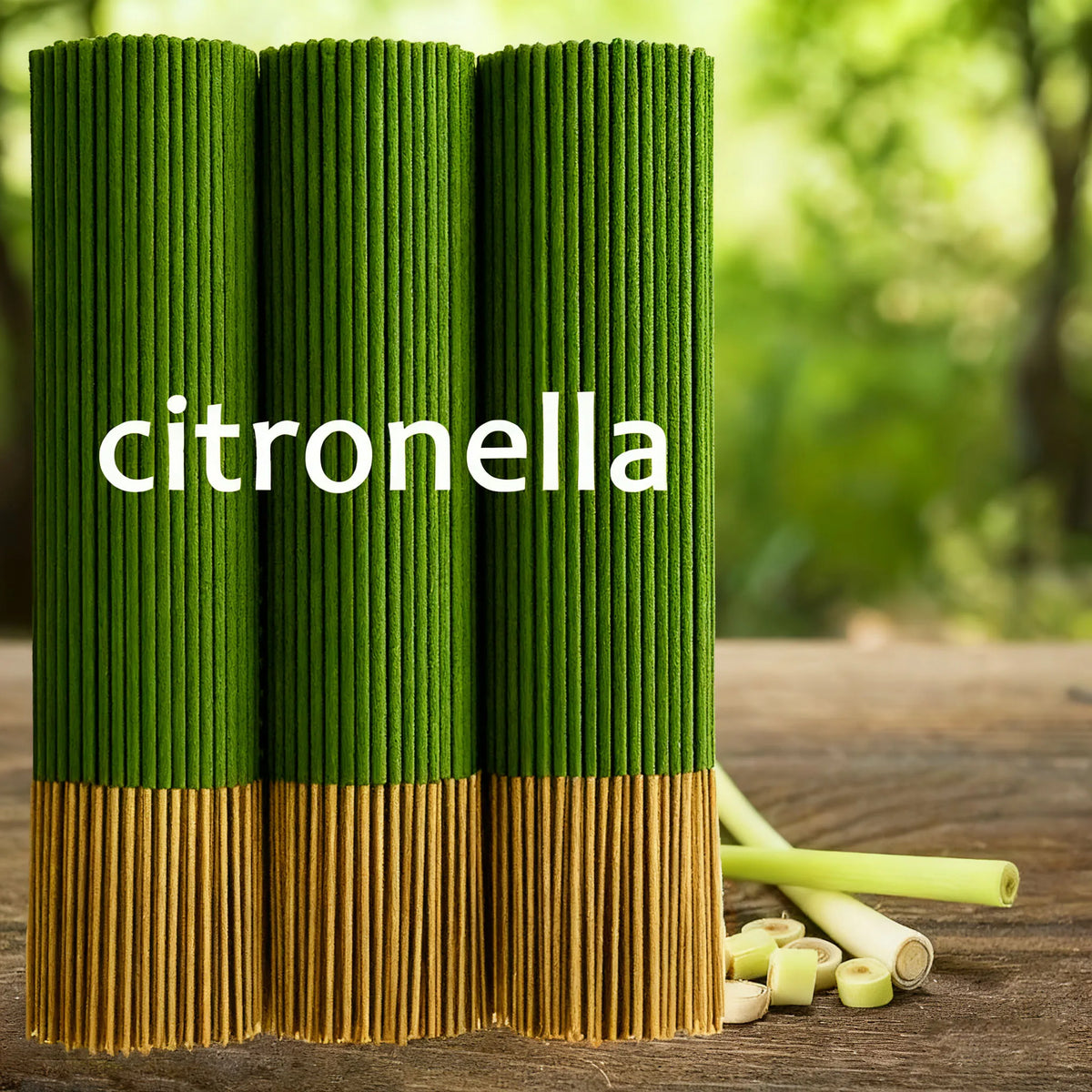 Three bundles of green citronella incense sticks with lemongrass pieces on a wooden table