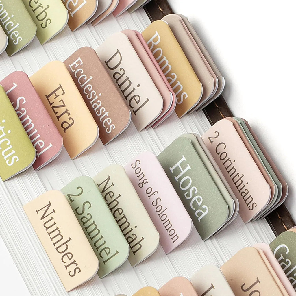 Self-adhesive bohemian style index tabs for a bible in soft muted colors like pastel green, pink, and tan.