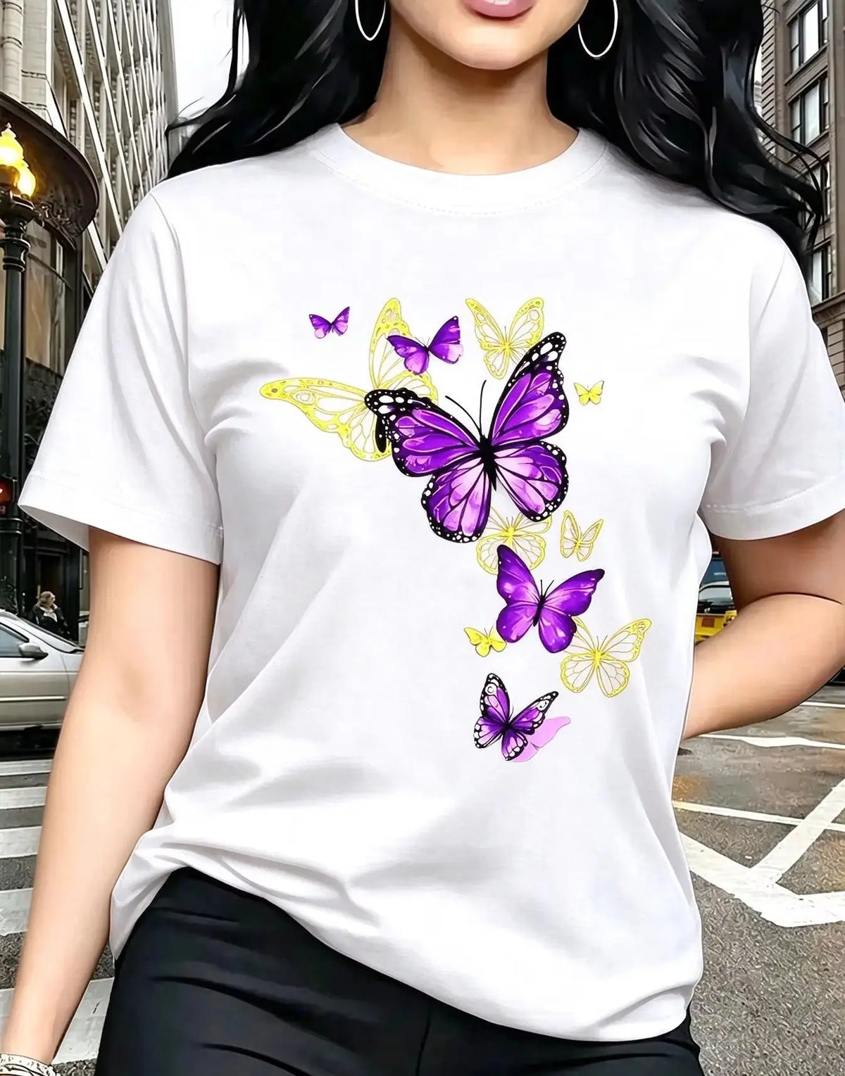 A white short-sleeved t-shirt with a printed butterfly design, worn by a woman.