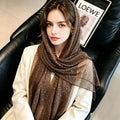 Woman wearing a brown sequin lightweight scarf as a headscarf