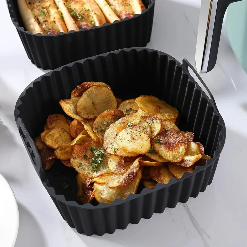 Black silicone air fryer liner filled with potato chips