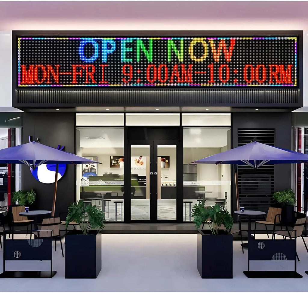 Programmable LED message board mounted above the entrance of an outdoor restaurant storefront