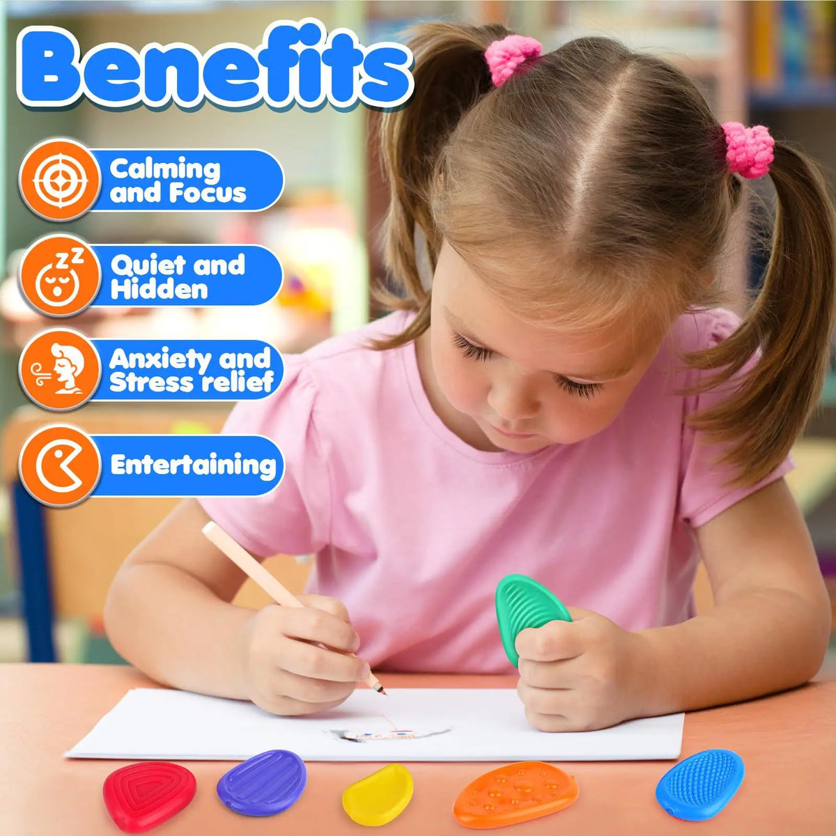Child drawing at a table with sensory fidget stones nearby