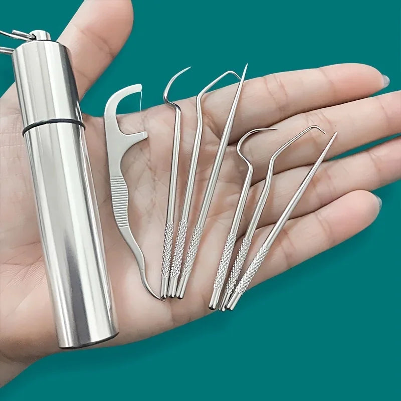 A hand holding a stainless steel metal toothpick and dental floss pick set with a portable keychain case.