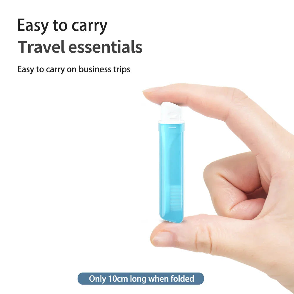 A hand holding a blue foldable travel toothbrush