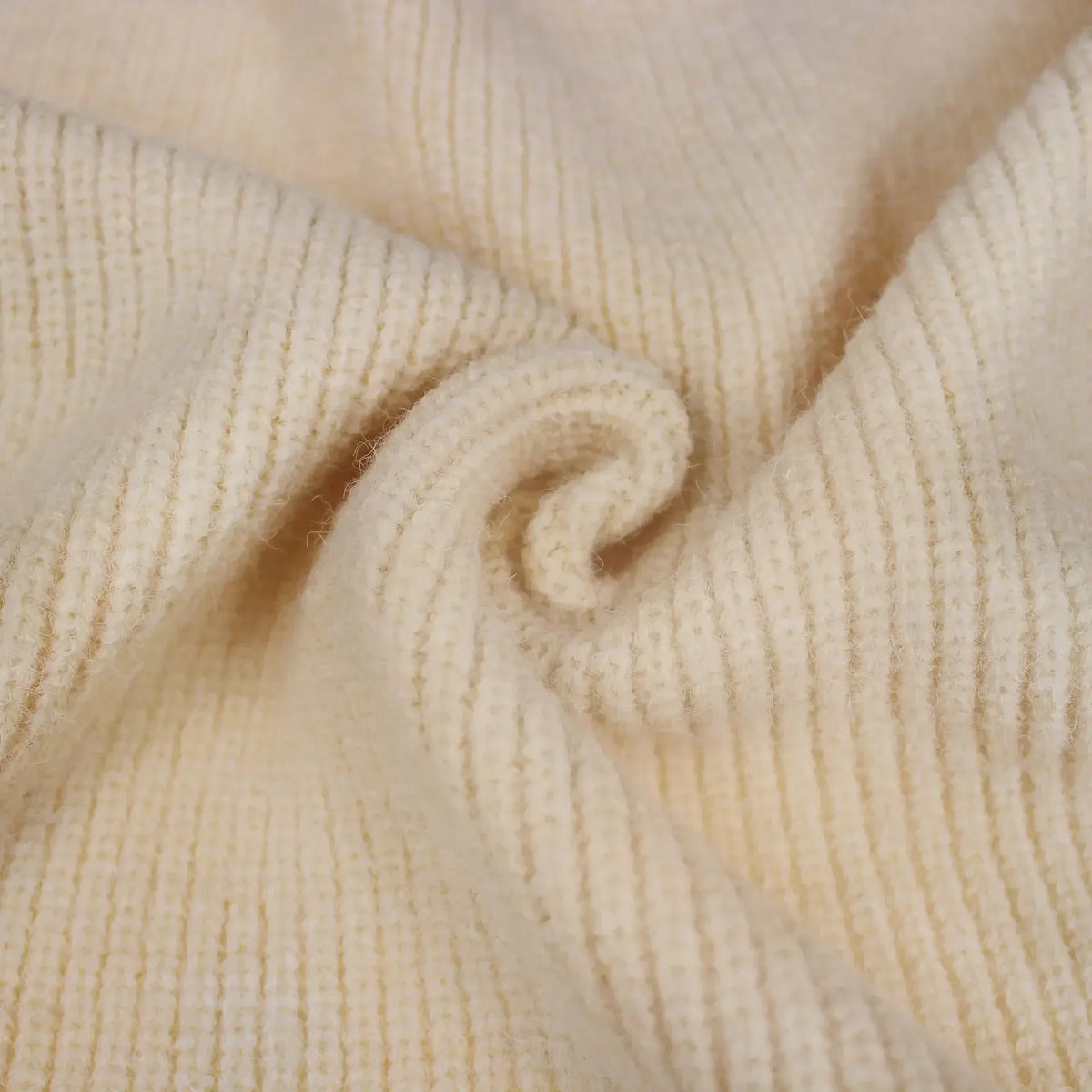 Close up detail of beige ribbed knit fabric texture.